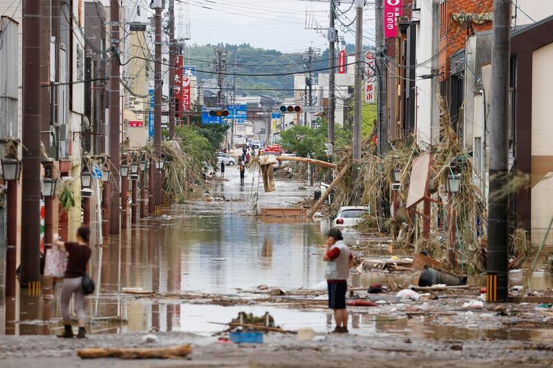 A street is flooded following a heavy rain in Hitoyoshi, Kumamoto prefecture. Kyodo News via AP