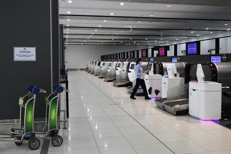 Check-in terminals are empty at Melbourne Airport in Victoria. The state has entered a 'circuit-breaker lockdown' for five days amid fears the highly infectious UK strain of coronavirus has spread in the community.  EPA
