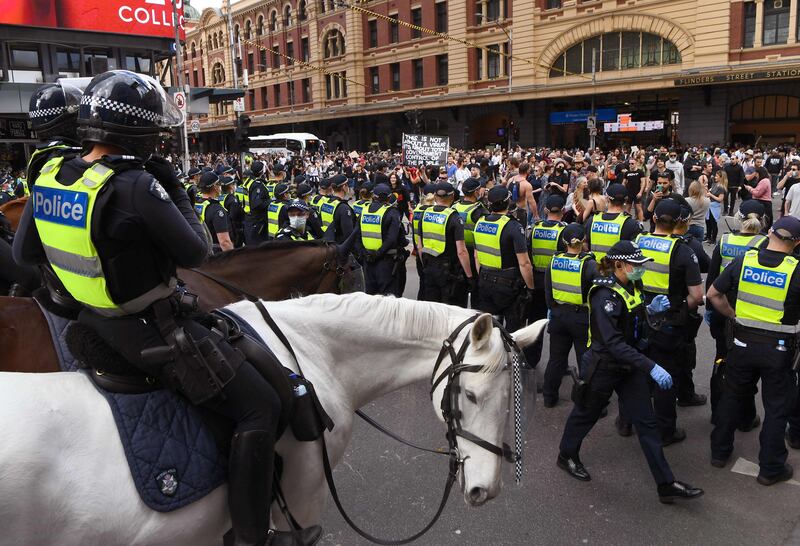 Protesters march through the streets during an anti-lockdown rally in Melbourne on Saturday. Photo: AFP