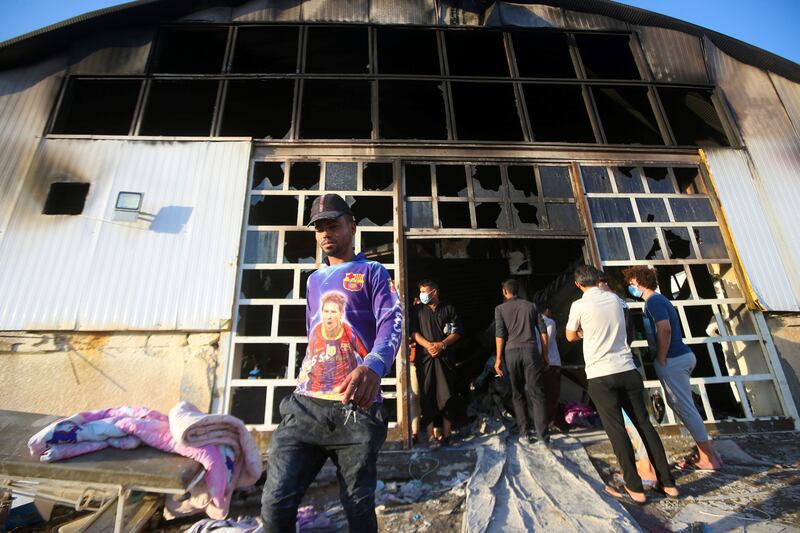 People inspect the damage after a fire at a hospital in the city of Nasiriyah in southern Iraq. At least 92 people were killed while dozens were injured.