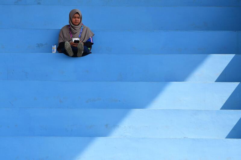 An Indonesian woman watches the awards ceremony for the mixed doubles soft tennis event at the 2018 Asian Games in Palembang.  AFP