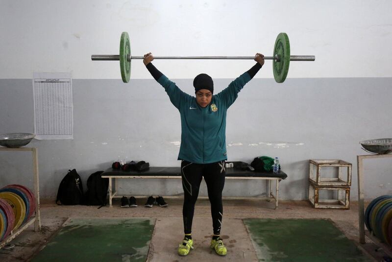 To mark the occasion of International Women's Day on March 8, 2018 AFP presents a series of 45 photos depicting women performing roles or working in professions more traditionally held by men.  More images can be found in www.afpforum.com  Search SLUG  "WOMEN-DAY -PACKAGE". 
Huda Salem, a 20-year-old member of the Iraqi national weightlifting team, lifts weights as she trains at a gym in Baghdad on February 22, 2018.  
In the ring, battling flames or lifting off into space, women have entered professions generally considered as men's jobs. For International Women's Day, AFP met with women breaking down the barriers of gender-bias in the work world. / AFP PHOTO / AHMAD AL-RUBAYE