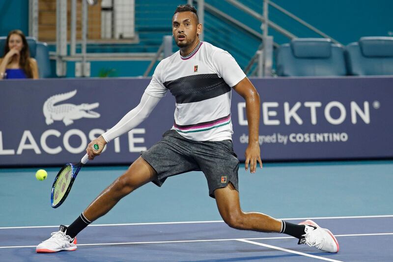 Mar 24, 2019; Miami Gardens, FL, USA; Nick Kyrgios of Australia hits a no-look volley against Dusan Lajovic of Serbia (not pictured) in the third round of the Miami Open at Miami Open Tennis Complex. Mandatory Credit: Geoff Burke-USA TODAY Sports