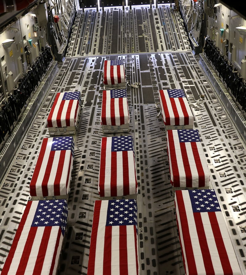 Flag-draped coffins of US service members are loaded on to a transport aircraft during a ramp ceremony at Hamid Karzai International Airport in Kabul, Afghanistan. Reuters