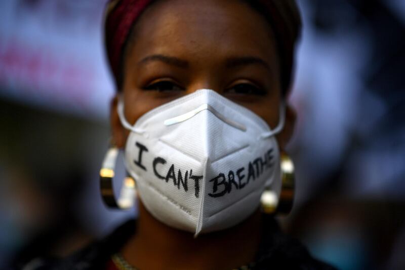 A woman wears a mask reading 'I can´t breathe' in Madrid, during a demonstration against racism and in solidarity with the Black Lives Matter movement.  AFP