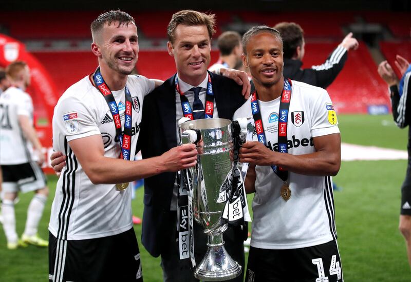 Soccer Football - Championship Play-Off Final - Brentford v Fulham - Wembley Stadium, London, Britain - August 4, 2020  Fulham manager Scott Parker, Joe Bryan and Bobby Reid pose for photos as they celebrate promotion to the premier league with the trophy after winning the match, as play resumes behind closed doors following the outbreak of the coronavirus disease (COVID-19)  Action Images via Reuters/Matthew Childs