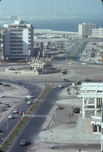 Downtown Abu Dhabi 1975 with the dusty roundabout at the junction of the roads then known as Khalifa Street, Al Istiqlal Street and Airport Road and its improbable, many minareted mosque. Called the 'Mickey Mouse mosque' by Western expats, the Al Fahim mosque was actually commissioned in the 1960s as an act of piety by Abduljalil Mohammed Al Fahim, the scion of a local family whose fortune was to become synonymous with the emirate's economic rise. (Photo by Alain Saint-Hilaire) *** Local Caption ***  rv27au-timeframe-downtown.JPG