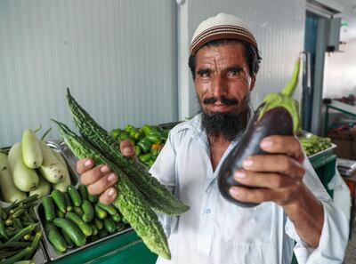 Abu Dhabi, U.A.E., July 30, 2018.   Fruits and Vegetable Market at Al Mina.  -- Sher Khan shows of his fresh vegetables. 
Victor Besa / The National
Section:  NA
Reporter:  Anna Zacharias
