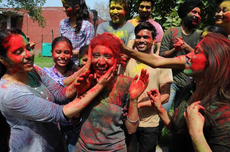 Indian students from Guru Nanak Dev University take part in Holi festival celebrations at the university campus in Amritsar, India. Holi is celebrated on the full moon day and marks the beginning of the spring season.  EPA