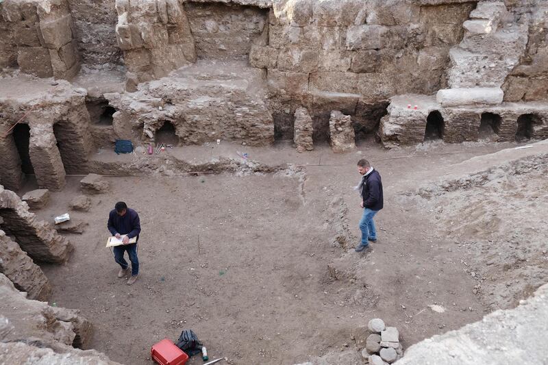 Antiquities Department employees survey a section of the Roman baths in downtown Amman, Jordan. Amy McConaghy / The National