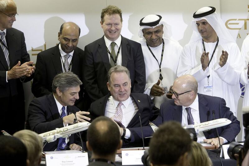 James Hogan, Etihad’s chief executive, sits between Ray Conner, left, Boeing’s chief for commercial airplanes, and David Joyce, the chief of GE Aviation, at the signing of the aircraft and engine deal at the Dubai Airshow. Jaime Puebla / The National