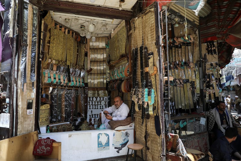 A merchant at his shop selling traditional Yemeni daggers