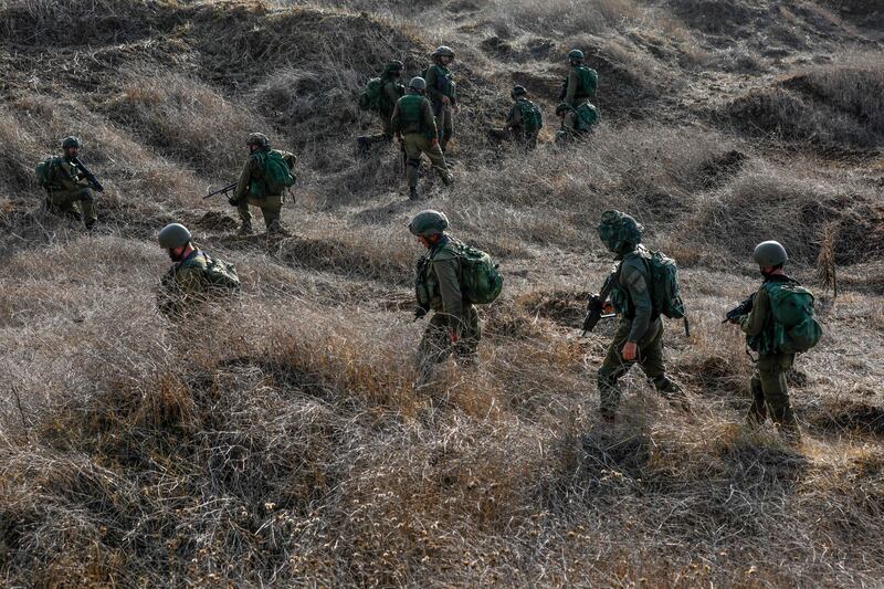 Israeli soldiers take part in an military exercise near Kibbutz Ortal in the Israel-annexed Golan Heights near the Lebanon border on November 15, 2023, amid increasing cross-border tensions as fighting continues with Hamas militants in the southern Gaza Strip. AFP