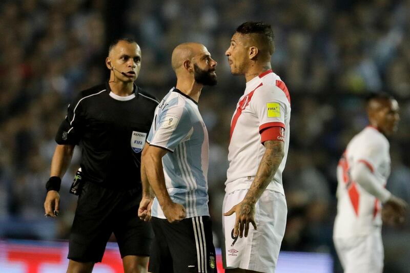 
                  Argentina's Javier Mascherano, center, argues with Peru's Ivan Bulos, right, during a World Cup qualifying soccer match as referee Wilton Sampaio, left, looks on at La Bombonera stadium in Buenos Aires, Argentina, Thursday, Oct. 5, 2017. (AP Photo/Victor R. Caivano)
               