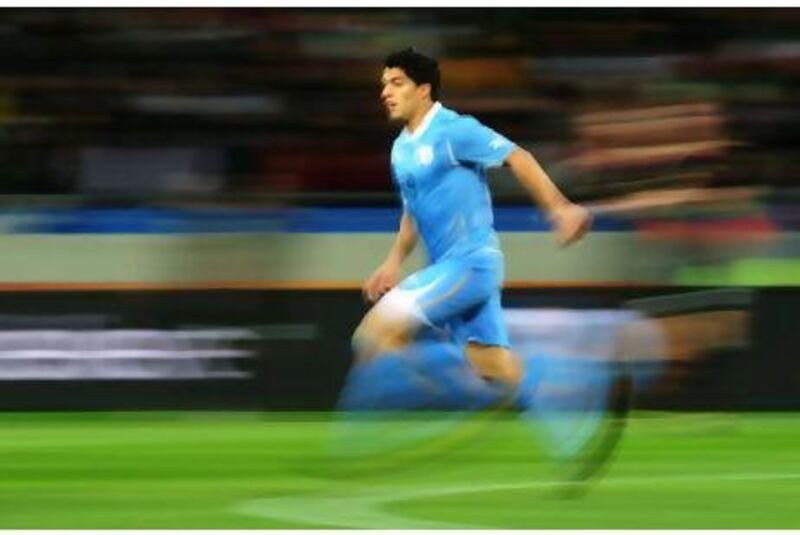 Luis Suarez in action at the World Cup, where his goal-line handball deprived Ghana of a place in the semi-finals.