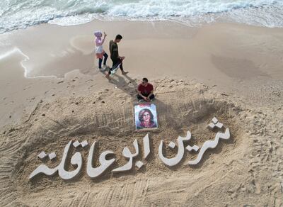 A sand sculpture reads ‘Shireen Abu Akleh’ on a beach in Gaza city.  Reuters