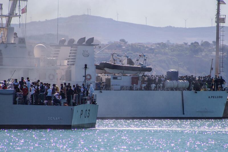 Migrants arrive in Porto Empedocle, Sicily, aboard two military ships after being transferred from the island of Lampedusa, where a number of small boat carrying migrants arrived in the last days, Monday, July 27, 2020. (Fabio Peonia/LaPresse via AP)