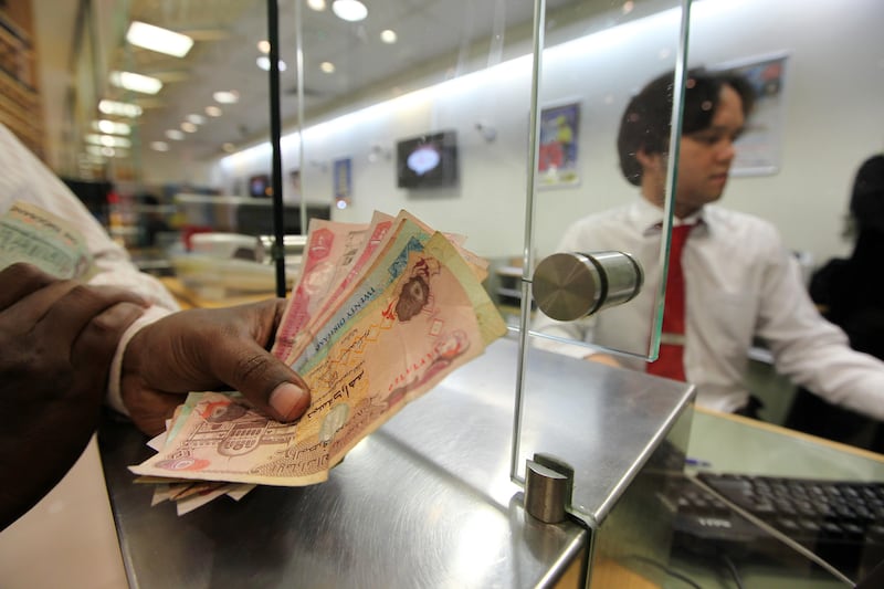 DUBAI , UNITED ARAB EMIRATES Ð July 5 :  Expats sending money to India from UAE Exchange at Lulu hypermarket in Al Barsha in Dubai. ( Pawan Singh / The National ) For News
