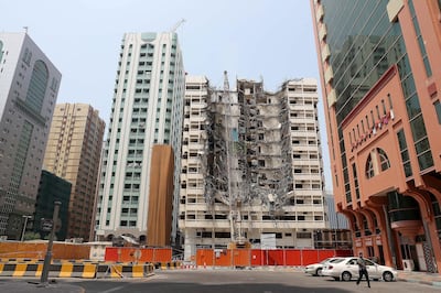 ABU DHABI , UNITED ARAB EMIRATES, September 9 – 2018 :- Demolition of one of the old building is going on at the Tourist Club area in Abu Dhabi. ( Pawan Singh / The National )  For News. Story by Anna/ John