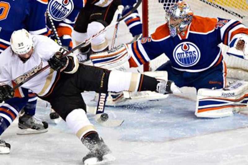 Anaheim's Matt Beleskey is stopped by Edmonton Oilers goalie Nikolai Khabibulin.