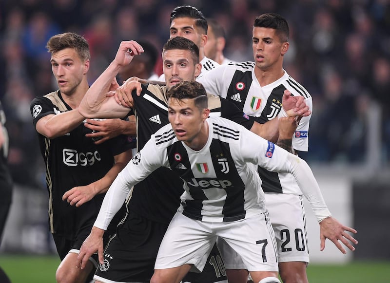 Juventus' Cristiano Ronaldo and Joao Cancelo in action with Ajax's Dusan Tadic. Reuters