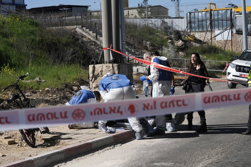 Israeli security forces inspect the scene of a stabbing attack at a checkpoint between Jerusalem and the West Bank. AP