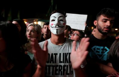 A demonstrator wears a mask during an anti-government protest in the southern city of Nabatiyeh, Lebanon October 22, 2019. REUTERS/Aziz Taher