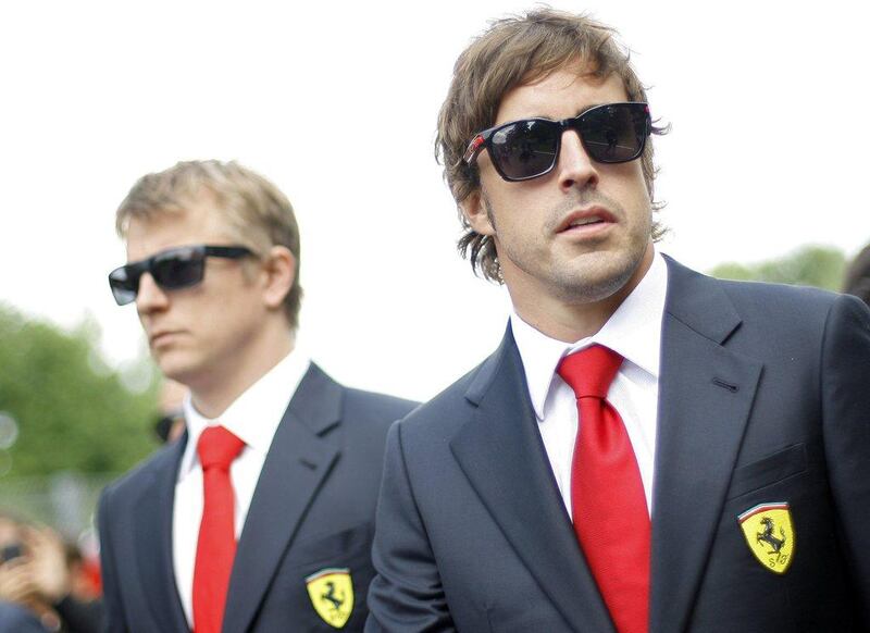 Ferrari drivers Fernando Alonso, right, and Kimi Raikkonen, left, are third and 12th in the F1 drivers' standings, respectively. Alessandro Garofalo / Reuters 