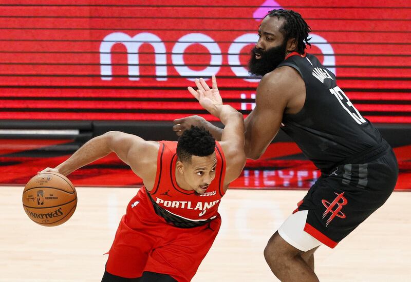 PORTLAND, OREGON - DECEMBER 26: CJ McCollum #3 of the Portland Trail Blazers dribbles past James Harden #13 of the Houston Rockets during overtime at Moda Center on December 26, 2020 in Portland, Oregon. NOTE TO USER: User expressly acknowledges and agrees that, by downloading and/or using this photograph, user is consenting to the terms and conditions of the Getty Images License Agreement.   Steph Chambers/Getty Images/AFP
== FOR NEWSPAPERS, INTERNET, TELCOS & TELEVISION USE ONLY ==
