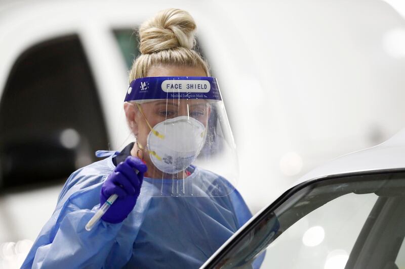 A medical practitioner performs a coronavirus test in the carpark of Bunnings in West Footscray in Melbourne, Australia. Getty