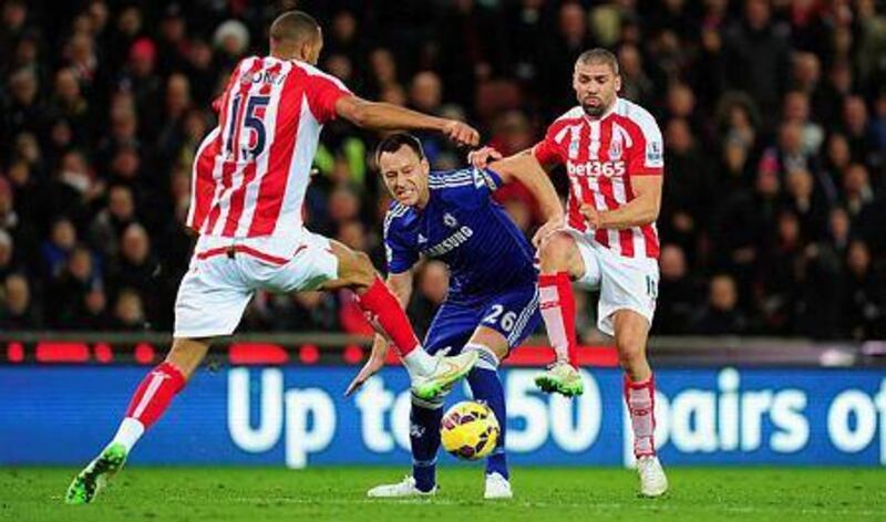 Chelsea player John Terry, centre, is challenged by Jonathan Walters, right, and Steven Nzonzi during their Premier League match at Britannia Stadium on December 22, 2014 in Stoke on Trent, England. (Photo by Stu Forster/Getty Images)



