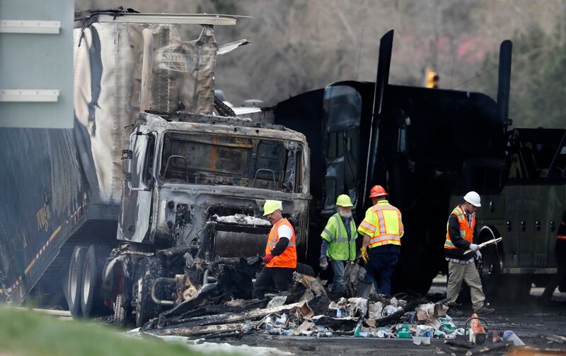 Workers clear debris on Interstate 70 in Lakewood, Colorado, in 2019, following a deadly pile-up involving a semi hauling lumber.  AP