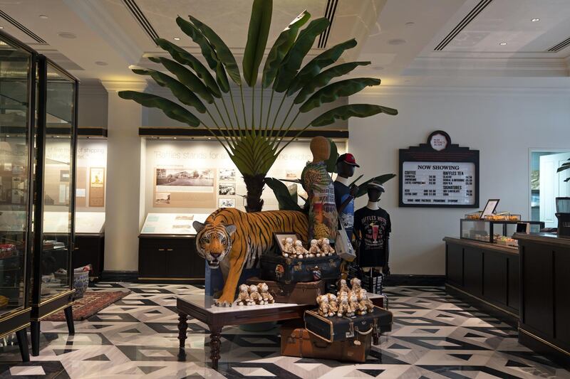 A stuffed tiger stands among merchandise displayed in the Raffles Boutique at the Raffles Hotel. Bloomberg