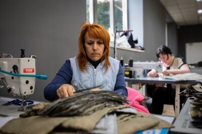 Nataliya Makodzob sews camouflage fabric to make bulletproof vests and body armour for those fighting for Ukraine against Russia. Oliver Marsden/The National