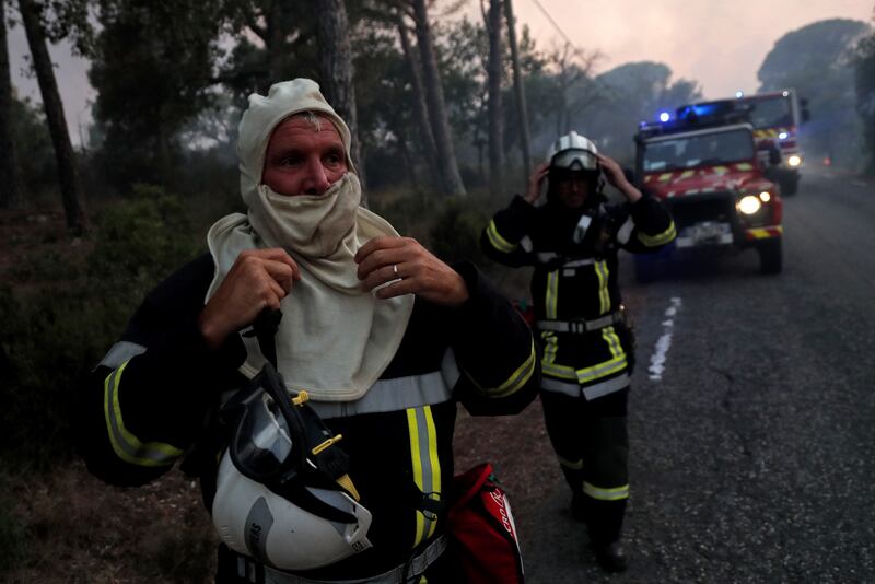 French firefighters take a rest while attempting to douse forest wildfires around Cannet des Maures.