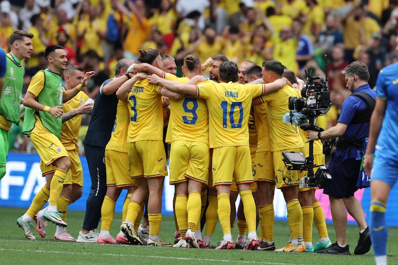 Players of Romania celebrate after the match. EPA