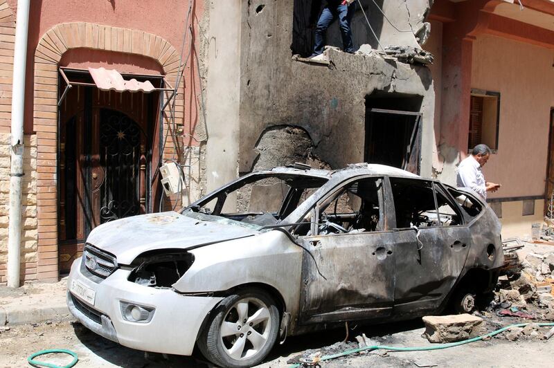 epa07512404 People inspect the damage after overnight shelling on the southern district of Abu Salim, Tripoli, Libya, 17 April 2019. According to media reports, four people were killed and dozens injured in shelling in the Abu Salim district of Tripoli. Forces loyal to Commander of the Libyan National Army (LNA) Khalifa Haftar are engaged in a military operation since early April to take control of the Libyan capital Tripoli.  EPA/STRINGER