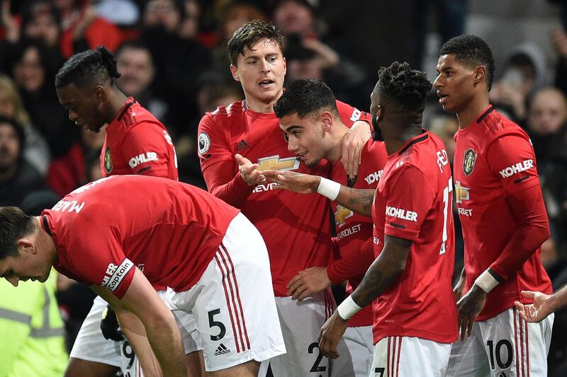 Manchester United's Swedish defender Victor Lindelof (C) celebrates with teammates after scoring an equaliser to make it 2-2 against Aston Villa. AFP