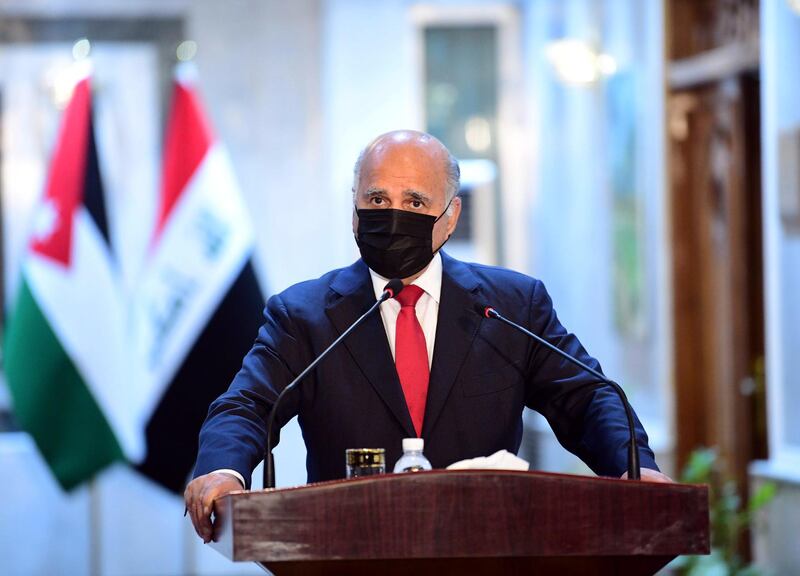 epa08506431 Iraqi Foreign Minister Fuad Hussein wears a protective mask during a a press conference with his Jordanian counterpart Ayman Safadi (unseen) at the Foreign Ministry in Baghdad, Iraq, 24 June 2020. Safadi is in Baghdad for talks with senior Iraqi officials.  EPA/MURTAJA LATEEF