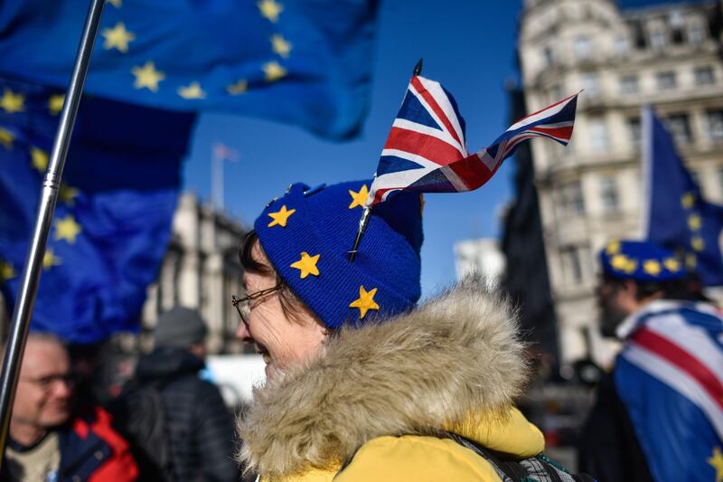 LONDON, ENGLAND - JANUARY 01: A pro-EU activist wears a Union Jack in her EU styled hat while protesting outside the Houses of Parliament on January 1, 2020 in London, England. The UK is due to leave the European Union this Friday, Jan 31st, after Britons voted to leave in the 2016 referendum. (Photo by Peter Summers/Getty Images)