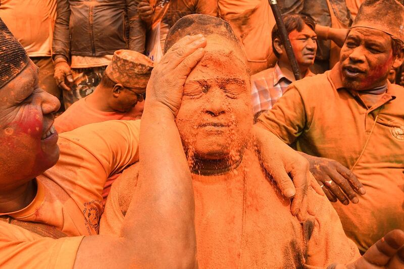 A man has his face covered with vermilion powder during the Bisket Jatra festival at Thimi, in Kathmandu's Bhaktapur District, Nepal. AFP