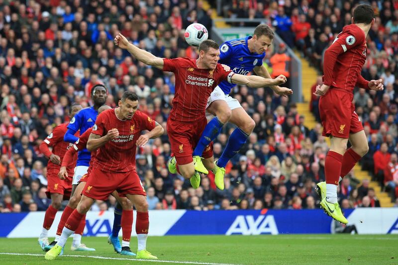 Liverpool's James Milner and Leicester City's Jonathan Evans vie for the ball. Associated Press