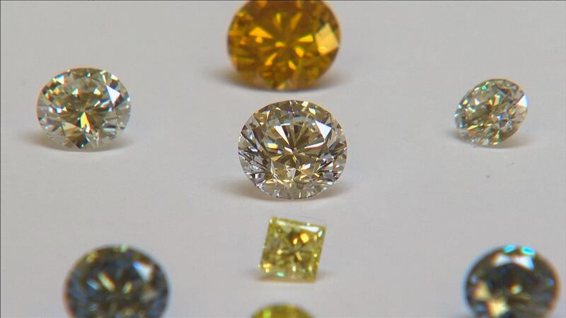 FILE PHOTO: A still image from video shows coloured synthetic diamonds on display at De Beers' International Institute of Diamond Grading and Research in Maidenhead August 15, 2016. REUTERS/Reuters TV/File Photo