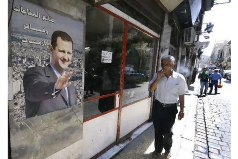 A portrait of Syrian President Bashar Assad with Arabic words reading:"Maker of surprises and victor against crisis," in Damascus, Syria. Washington is quietly working with Turkey to plan for a post-Assad future that could see Syria's various ethnic groups battle for control of the country, according to a report. Muzaffar Salman) / AP Photo