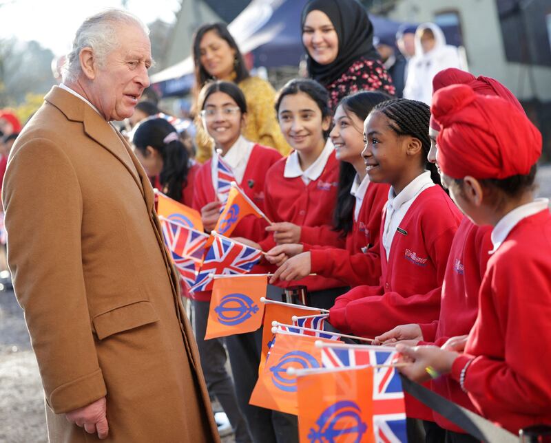 The king meets schoolchildren in Luton. AFP