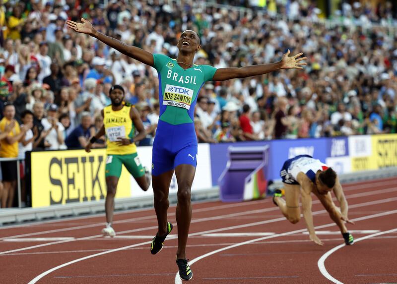 Alison Dos Santos celebrates while crossing the finish line to win the men's 400m hurdles final. EPA