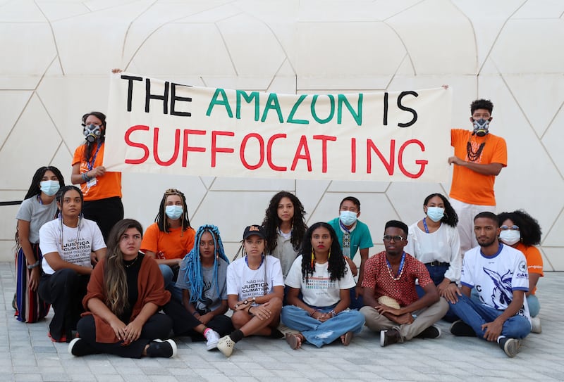 Activists from youth organisation Engajamundo stage a protest about smog caused by deforestation in the Amazon. Chris Whiteoak / The National