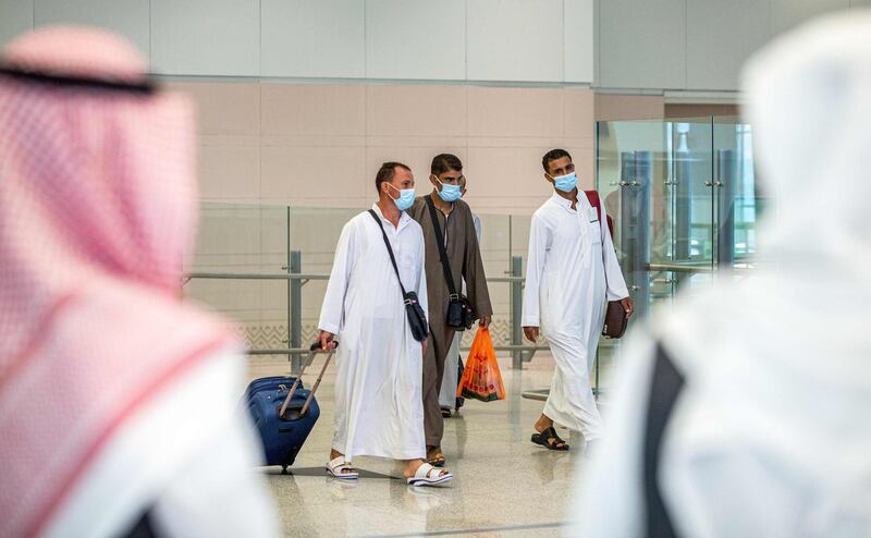A handout picture provided by the Saudi Ministry of Hajj and Umra on July 25, 2020, shows travellers, mask-clad due to the COVID-19 coronavirus pandemic, walking with luggage as part of the first group of arrivals for the annual Hajj pilgrimage, at the Red Sea coastal city of Jeddah's King Abdulaziz International Airport. The 2020 hajj season, which has been scaled back dramatically to include only around 1,000 Muslim pilgrims as Saudi Arabia battles a coronavirus surge, is set to begin on July 29. Some 2.5 million people from all over the world usually participate in the ritual that takes place over several days, centred on the holy city of Mecca. This year's hajj will be held under strict hygiene protocols, with access limited to pilgrims under 65 years old and without any chronic illnesses. - === RESTRICTED TO EDITORIAL USE - MANDATORY CREDIT "AFP PHOTO / HO / MINISTRY OF HAJJ AND UMRA" - NO MARKETING NO ADVERTISING CAMPAIGNS - DISTRIBUTED AS A SERVICE TO CLIENTS ===
 / AFP / Saudi Ministry of Hajj and Umra / - / === RESTRICTED TO EDITORIAL USE - MANDATORY CREDIT "AFP PHOTO / HO / MINISTRY OF HAJJ AND UMRA" - NO MARKETING NO ADVERTISING CAMPAIGNS - DISTRIBUTED AS A SERVICE TO CLIENTS ===
