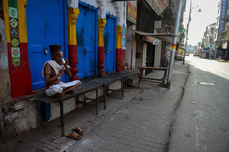 A man drinks tea outside his home during the lockdown n Allahabad.  AFP