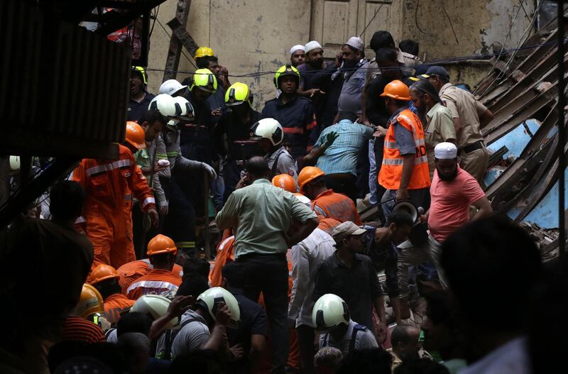 Rescuers work at the site of collapsed building. EPA